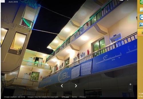 a view of a building with people on the balconies at Motel 35 in Alīābād