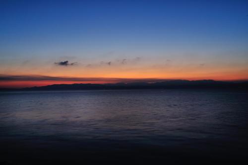 a sunset over a large body of water at Ibusuki Seaside Hotel in Ibusuki