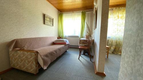 a small bedroom with a bed and a window at Dana Guest House in Roja