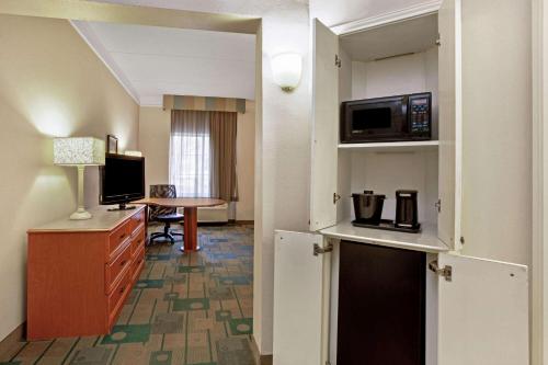 a hotel room with a kitchen and a living room at La Quinta by Wyndham Winston-Salem in Winston-Salem