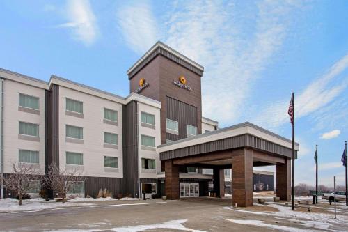 a hotel building with a sign on top of it at La Quinta by Wyndham Bismarck in Bismarck