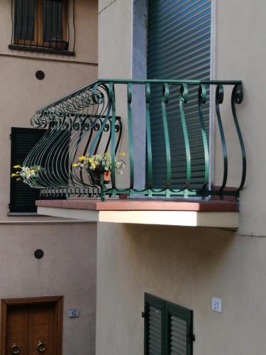 a balcony with a wrought iron railing on a building at Via Funicolare in Brunate