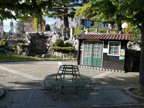 a bench and a table in front of a building at Via Funicolare in Brunate