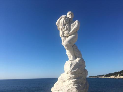 a statue of a woman holding a child on a rock at BOUTIQUE HOSTEL BY Cassis in Cassis