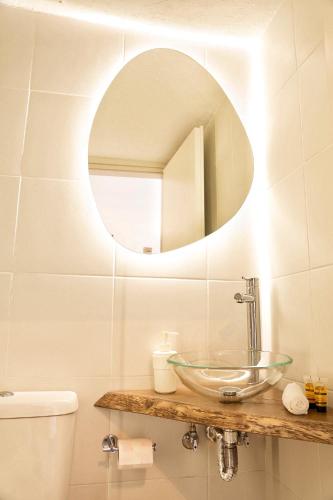 a bathroom with a sink and a mirror on the wall at Gigi Rooms in Poros
