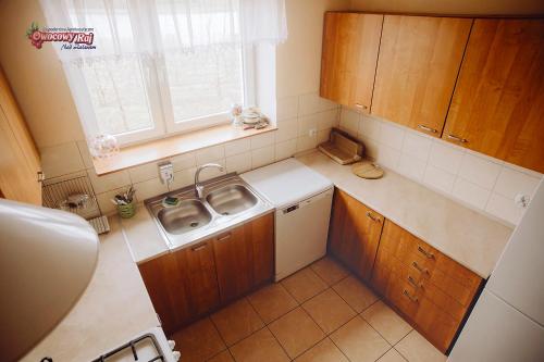 a small kitchen with a sink and a window at Owocowy Raj Nad Zalewem in Modła Królewska