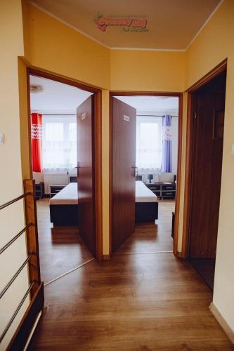 a hallway with two beds in a room with mirrors at Owocowy Raj Nad Zalewem in Modła Królewska