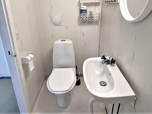 a small bathroom with a toilet and a sink at Tranquil Oasis in Northern oland-By Traum in Löttorp
