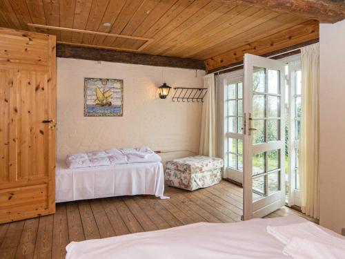 een slaapkamer met 2 bedden en een glazen schuifdeur bij Holiday home Højer VIII in Højer