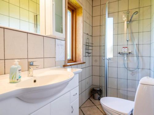 a bathroom with a sink and a toilet and a shower at 5 person holiday home in Nørre Nebel in Nørre Nebel