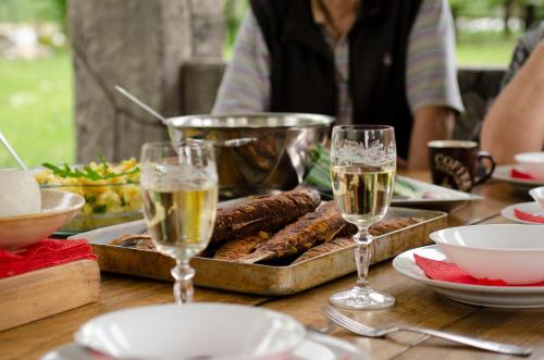 a table with glasses of champagne and food on it at Drinska laguna in Banja Koviljača
