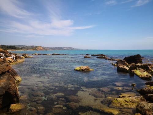 a body of water with rocks and the ocean at Holiday Beach Lumia in Sciacca