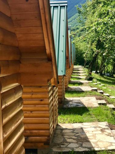 a side of a building with a pathway next to it at Rafting Tara Camp Highlander in Bastasi