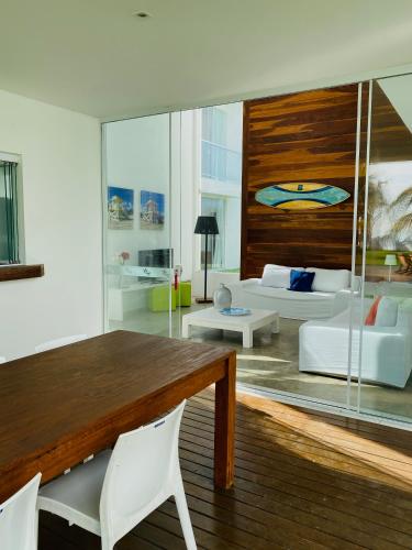 a living room with a table and a couch at B Blue Beachouses in Itacimirim