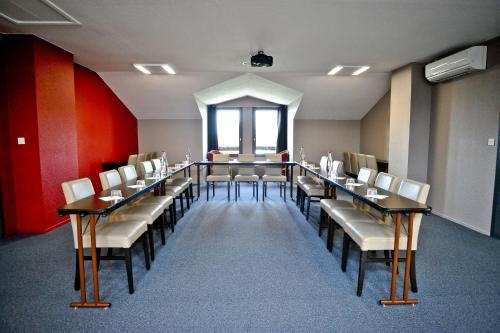 a conference room with a long table and chairs at Hotel Loreak in Bayonne