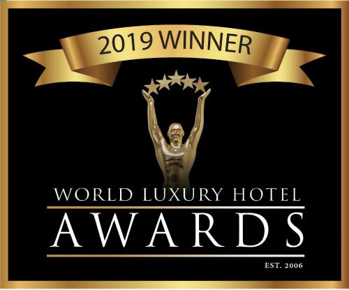a sign that says world luxury hotel awards with a swimmer at Marsden Lake Resort Central Otago in Cromwell