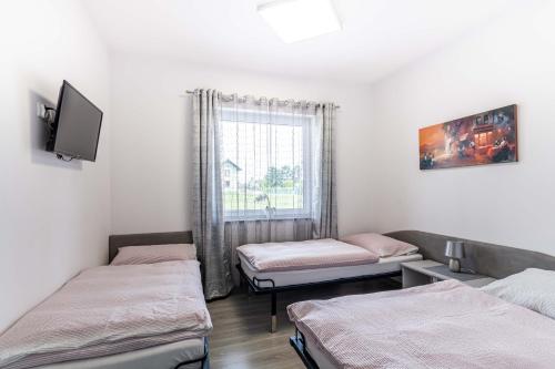 a room with two beds and a window at Motel OLIV in Oświęcim