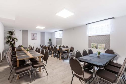 a classroom with tables and chairs in a room at Motel OLIV in Oświęcim