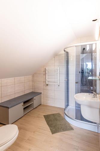 a bathroom with a shower and a sink and a toilet at Motel OLIV in Oświęcim