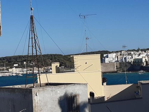 a building with a view of a harbor with boats at Casa Vacanze Ottantapassi in Otranto