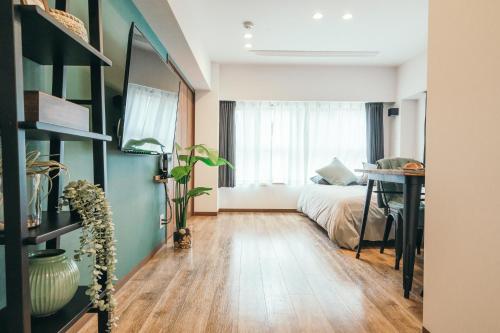 a bedroom with a bed and a desk in a room at City Hideout in Tokyo