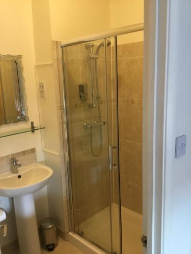 a bathroom with a shower and a sink at Pebbles Guest House in Southend-on-Sea