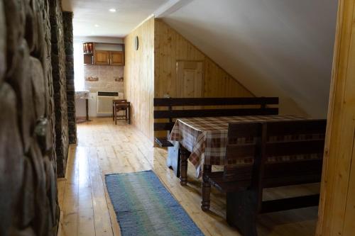 a attic room with a bed and a kitchen at Садиба в пані Рузі in Skole