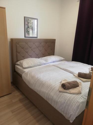 two beds in a bedroom with a towel on them at Apartments Nik in Selce