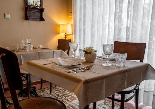 a dining room table with a table cloth on it at Julina Boutique Living in Mosta