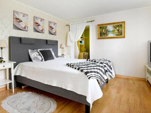 a bedroom with a large bed with a black and white comforter at 2 person holiday home in LYSEKIL in Lysekil