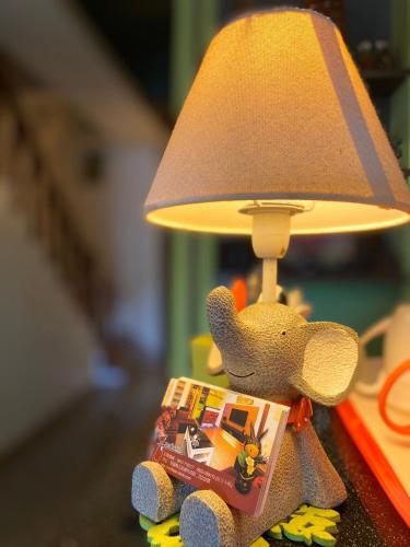 a toy elephant with a toy train under a lamp at Redbean Guesthouse in Wujie