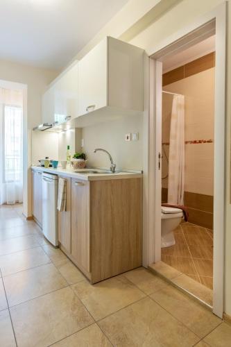 a kitchen with a sink and a toilet at Apartments Flora 1 in Burgas