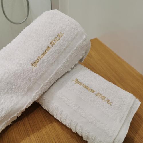two towels sitting on top of a table at Apartament IDEAL in Dziwnów