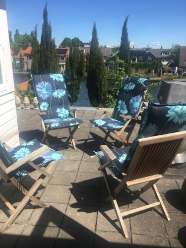 a group of lawn chairs sitting on a patio at Luc's Place, jaccuzi, waterbed in Zoeterwoude