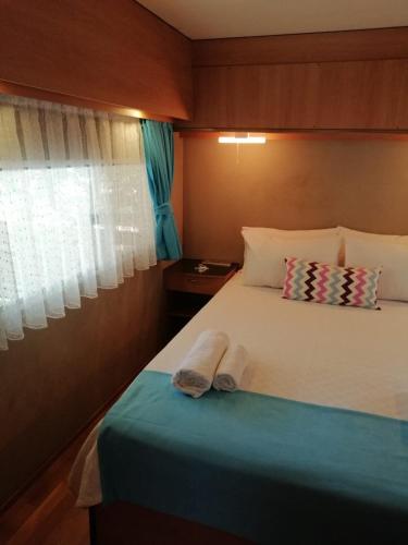 a bedroom with a bed with two towels on it at Kara Kedi Beach Bungalow in Cıralı