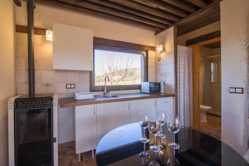 a kitchen with a table with wine glasses on it at El BURGO DE OSMA ALOJAMIENTO RURAL VILLA BAGH in El Burgo de Osma