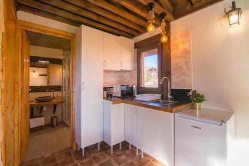 a kitchen with white cabinets and a sink at El BURGO DE OSMA ALOJAMIENTO RURAL VILLA BAGH in El Burgo de Osma