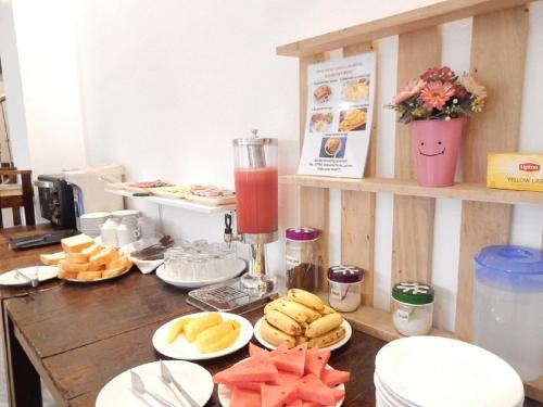 a table topped with plates of food and a drink at Vang Vieng Camellia Hotel in Vang Vieng