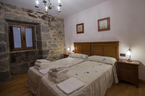 Un dormitorio con una cama con toallas. en Alojamiento Rural URGAIN I y II, en Lekunberri