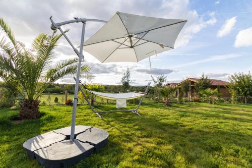 a hammock and an umbrella in a yard at El BURGO DE OSMA ALOJAMIENTO RURAL VILLA BAGH in El Burgo de Osma