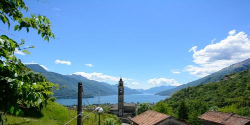 a view of a lake and a clock tower at Beautiful lake view apartment in Gravedona - Larihome A01 in Gravedona