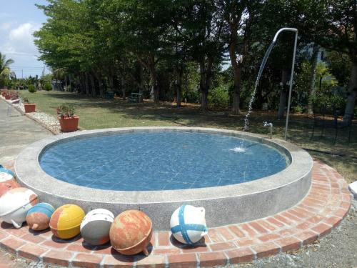 a swimming pool with a fountain with beach balls around it at Coconutpalm Home in Hengchun South Gate