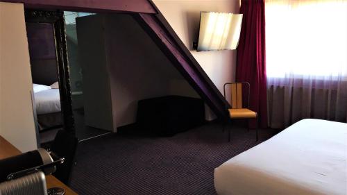 a hotel room with a bed and a mirror at Best Western Citadelle in Besançon