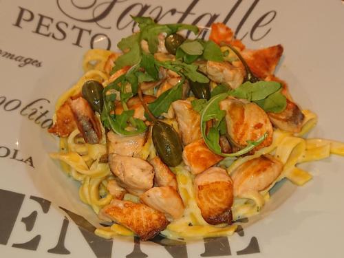 a plate of pasta with shrimp and vegetables on it at Hôtel-Restaurant Le Lion d'Or in Porrentruy