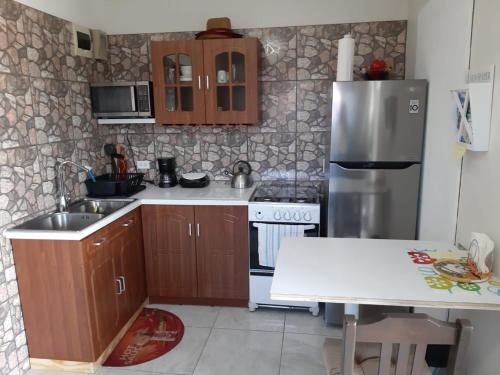 a kitchen with a sink and a refrigerator at Tropical Studio Apartment in Palm-Eagle Beach