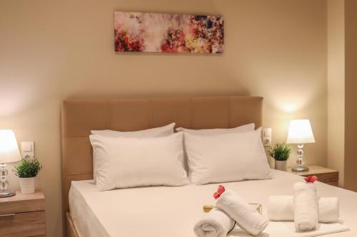 a bedroom with a bed with towels on it at Chrissomallis Apartments in Skiathos Town