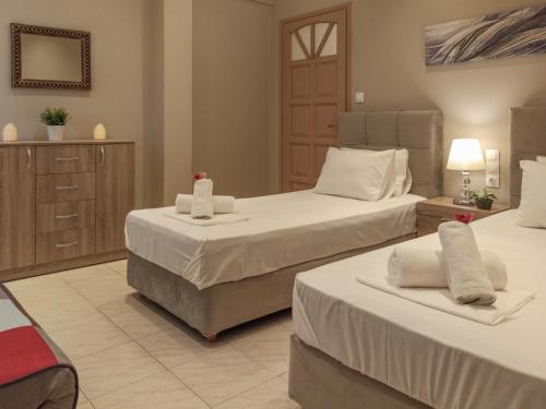 a hotel room with two beds with towels on them at Chrissomallis Apartments in Skiathos Town