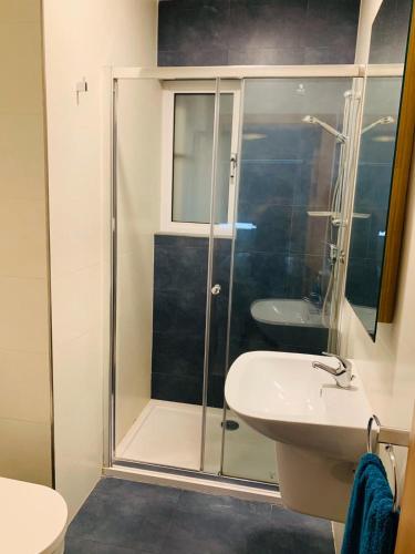 a bathroom with a shower and a toilet and a sink at Hostel Malti Budget in St Julian's