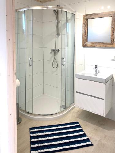 a bathroom with a shower and a sink at Mamma Mia Resort in Łukęcin