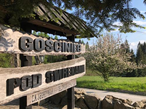 a couple of wooden signs that saypoolsurconservancy andpod survey at Gościniec Pod Smrekami in Czorsztyn